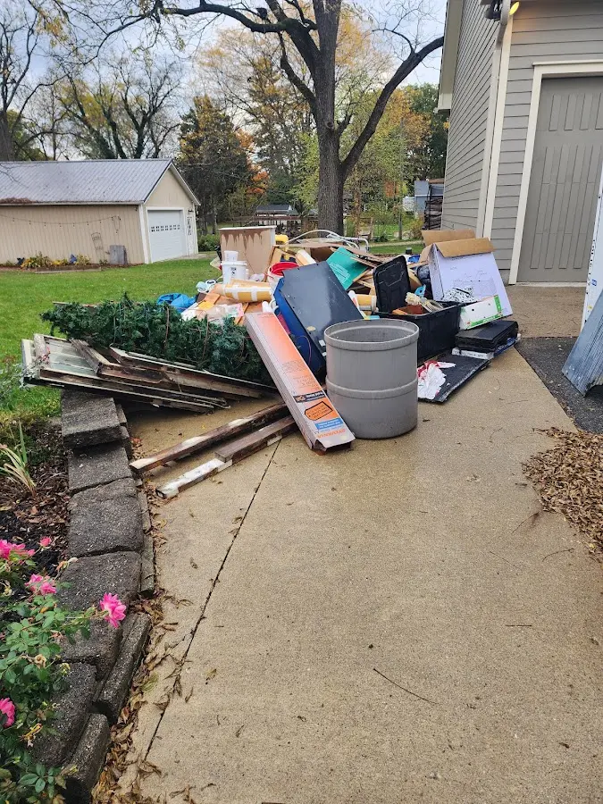 Dumpster being loaded with debris for Estate Cleanout Dumpster Rental in Merrimac
